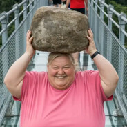 Woman with Big Rock on Bridge