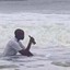 Bloke in sea with pint